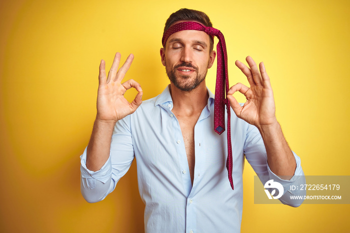 Hangover business man drunk and crazy for hangover wearing tie on head relax and smiling with eyes closed doing meditation gesture with fingers. Yoga concept.