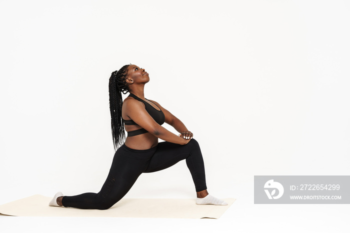 Black young woman standing in pose during yoga practice