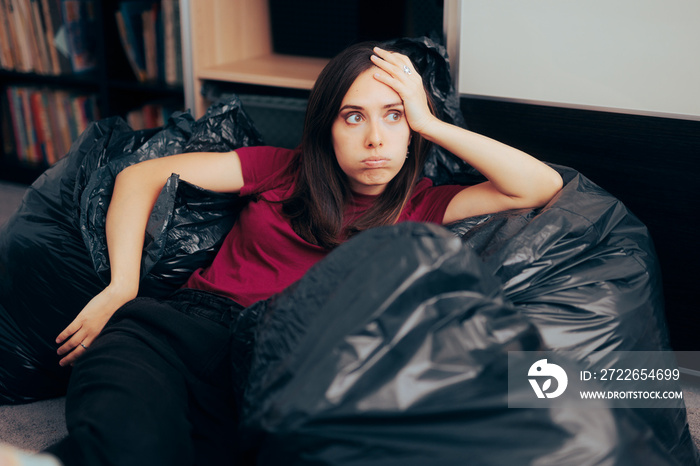 Woman Surrounded with Plastic Bags after Decluttering and Editing her Wardrobe. Unhappy fashionista feeling guilty for irresponsible overconsumption of fast fashion