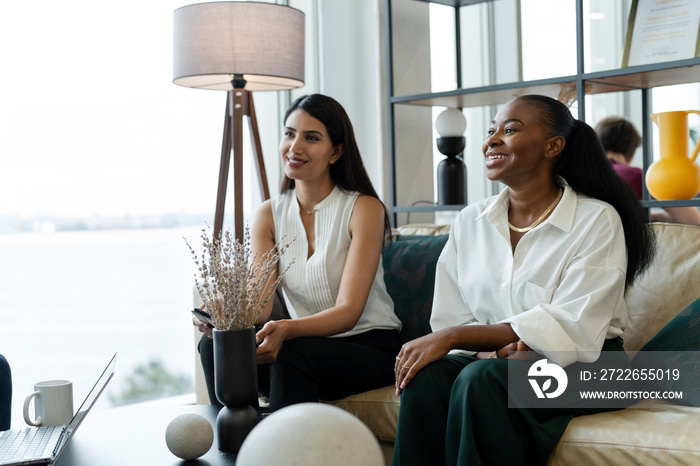 Businesswomen having meeting in office lobby