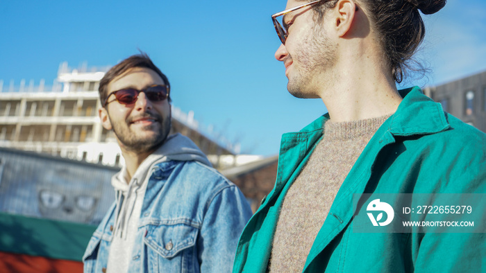 Smiling gay couple outdoors