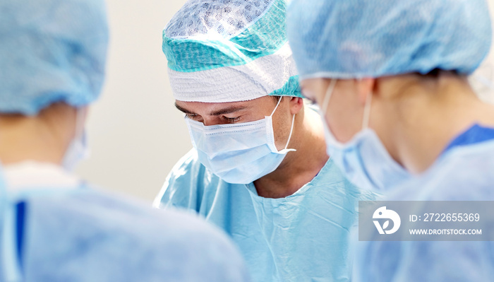 group of surgeons in operating room at hospital