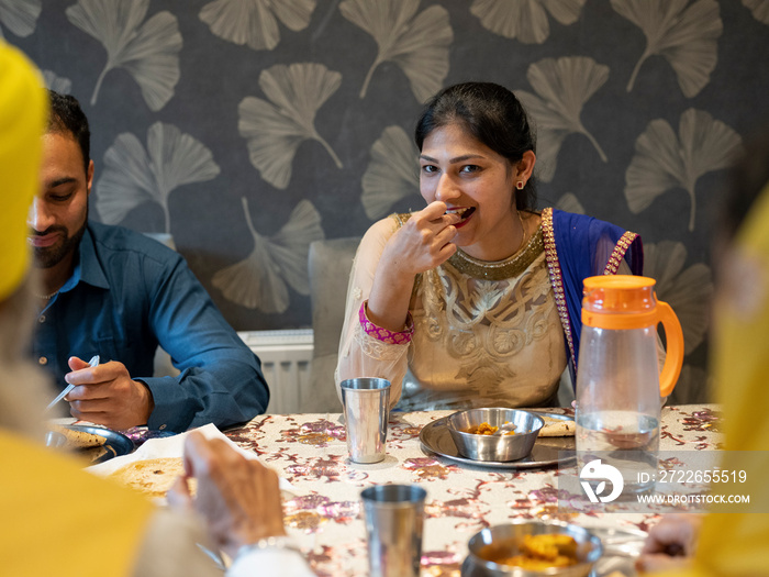 Family eating traditional Indian food at home