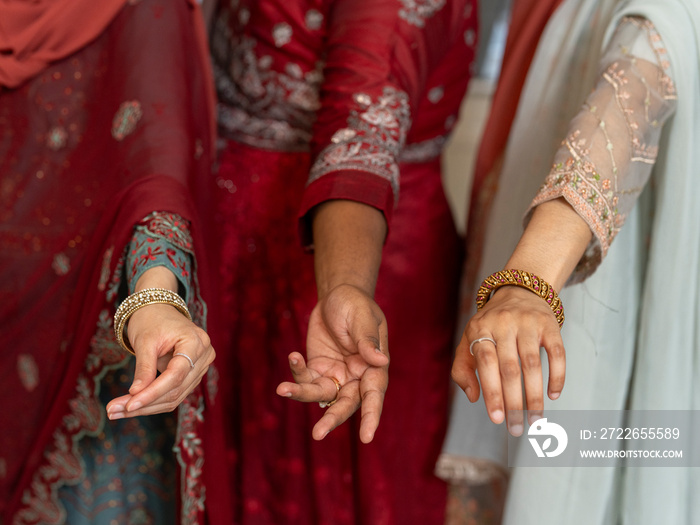 Women wearing jewelry on hands during Ramadan celebration