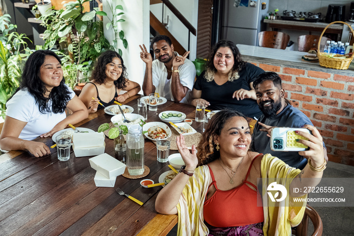 Group of friends sharing a meal together at home