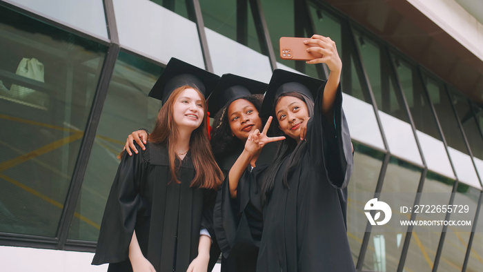 Group of friends having fun celebrating their graduation by taking pictures together.