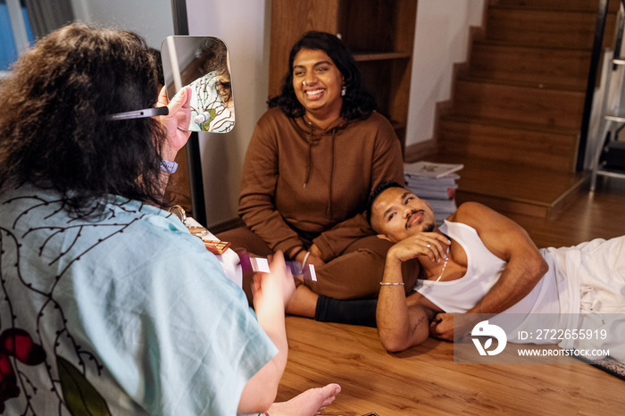 Group of friends doing each others make up at home during a sleepover