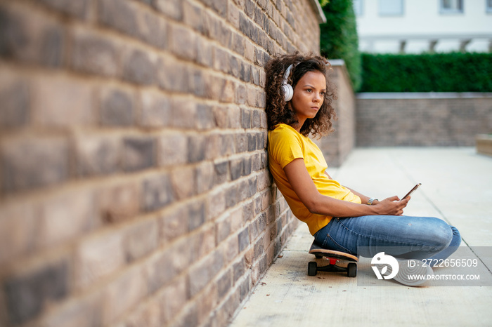 African skater girl using phone