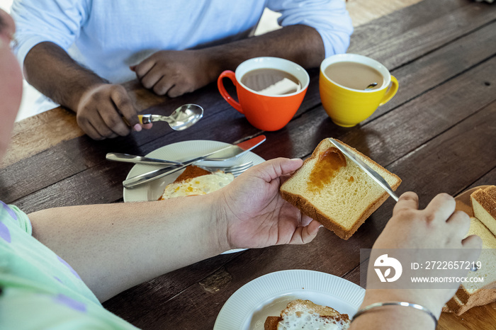 Couple making breakfast together at home in the morning