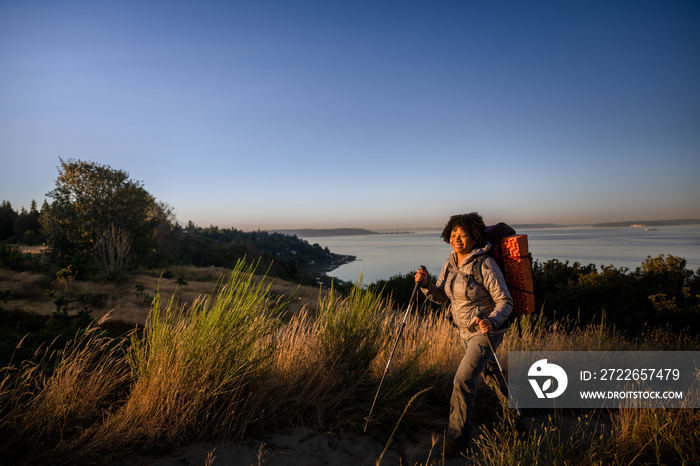 U.S. Army female soldier putting in the miles with an early morning hike in the NorthWest.