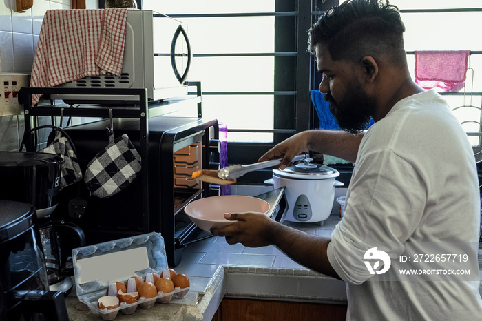 Couple making breakfast together at home in the morning