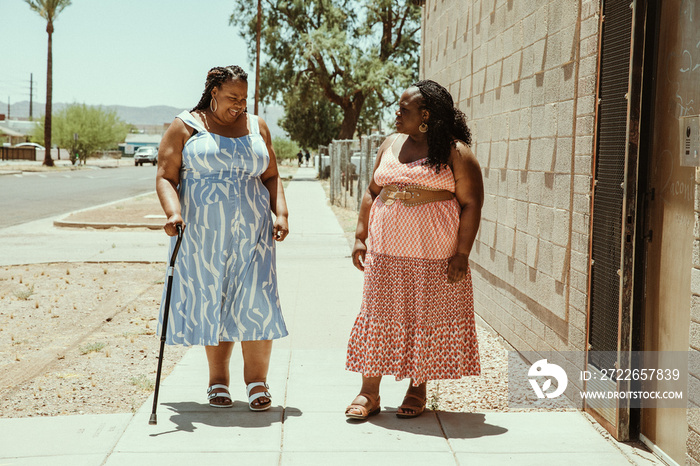 2 African American women walk down the street