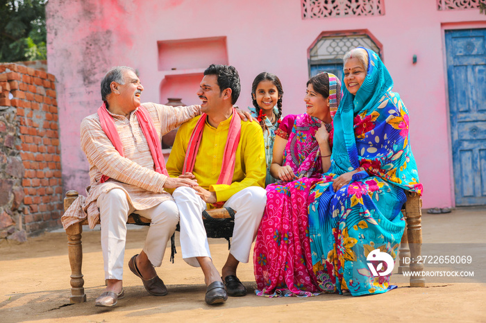 Happy Indian rural family setting at home.