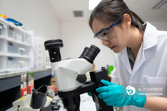 Asian scientist working in the lab,Researchers are research to find the results of the experiment,doctors are testing bloods to prevent and destroy new strains of the coronavirus through microscopy.