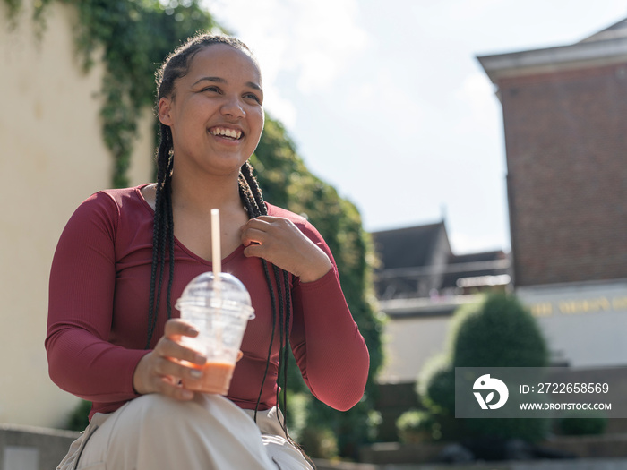 Portrait of smiling woman with smoothie