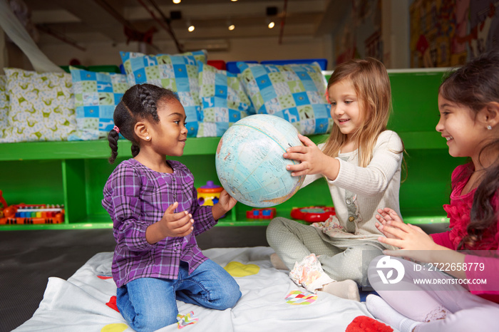 Children playing with globe