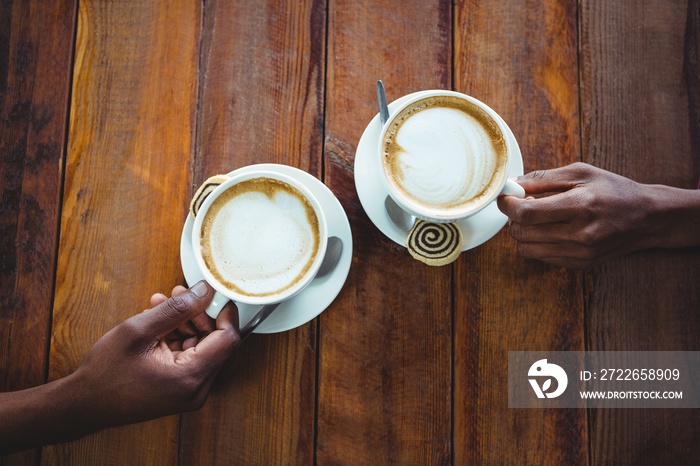 Couple hand holding cup of coffee