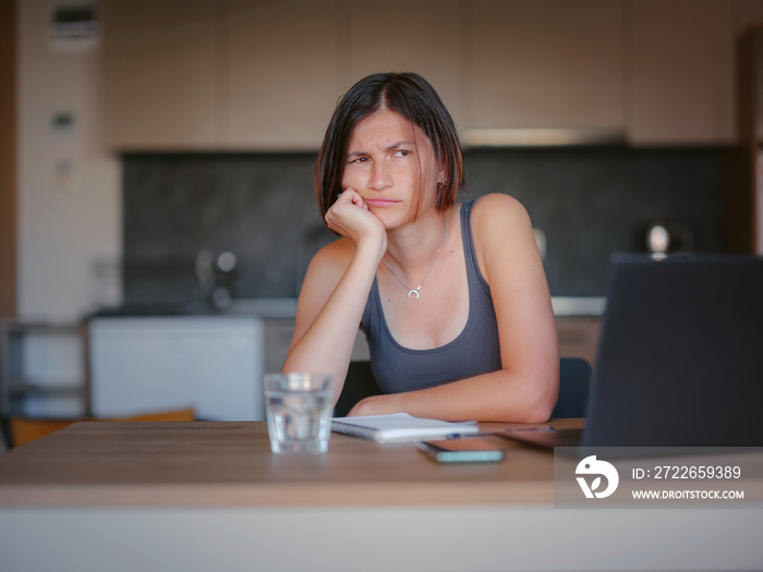 Frustrated sad woman feeling tired, worried about problem sitting at laptop, depressed girl worried about reading bad news online, debt notification email or negative message