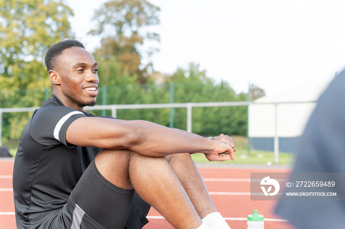 Athlete resting at sports track after training