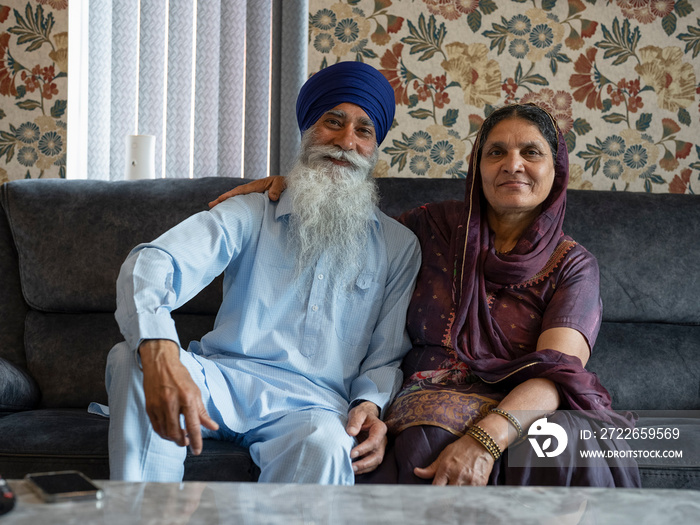 Portrait of senior couple in traditional clothing at home