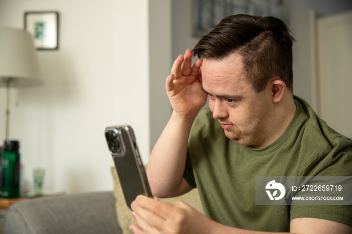 Man sitting on sofa and using smart phone