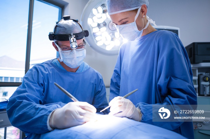 Surgeons performing operation in operation theater