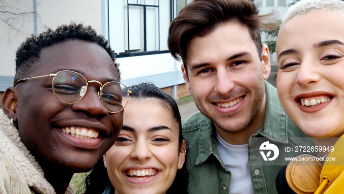 Diverse young student friends having fun on campus. Selfie perspective, college kids, millennials