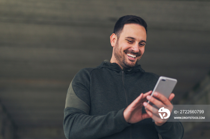 Man in sportswear using phone.