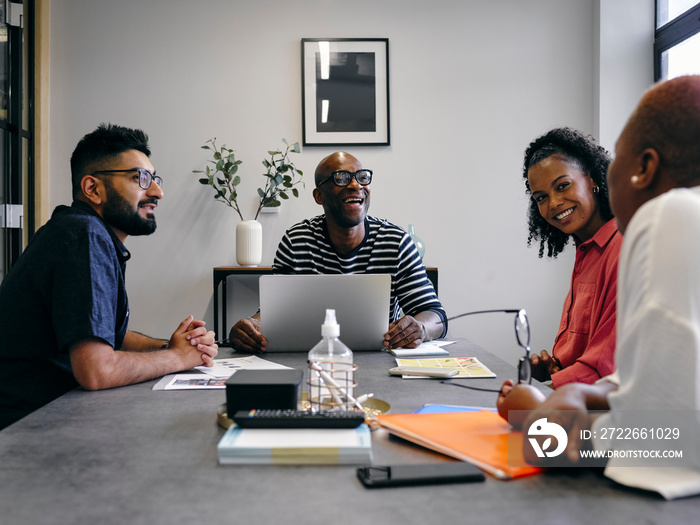 Colleagues talking at business meeting