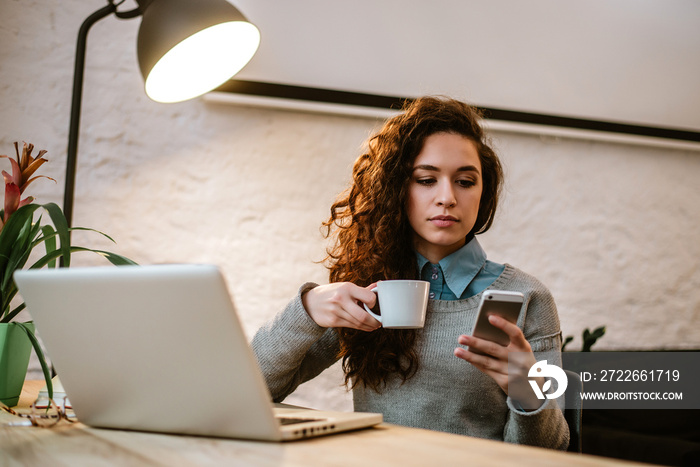 Young woman working at home or in a small modern office.