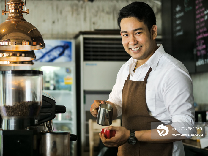 Happy Asian barista man working in cafe, lifestyle concept.