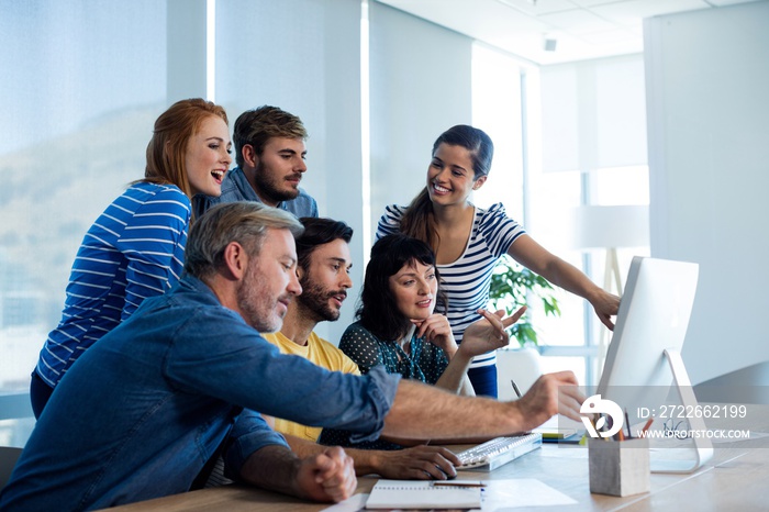 Creative business team discussing while working