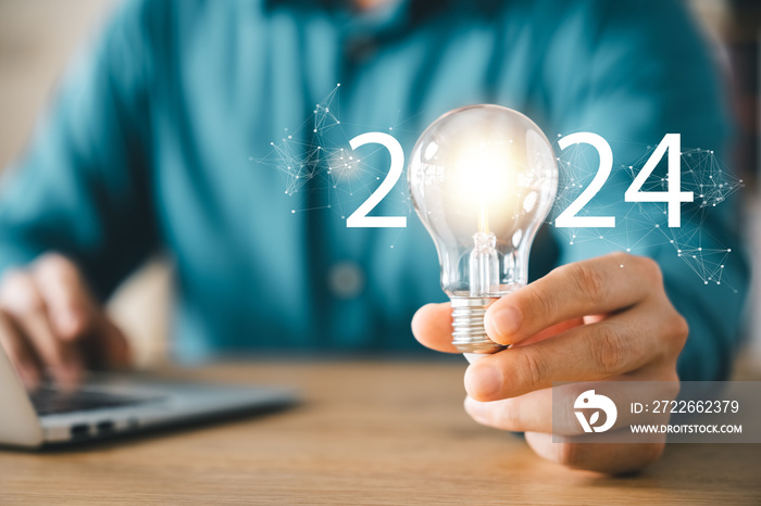 2024 creative concept, business man holding light bulb 2024 numbers, 2024 trend leader, setting goals for future business.