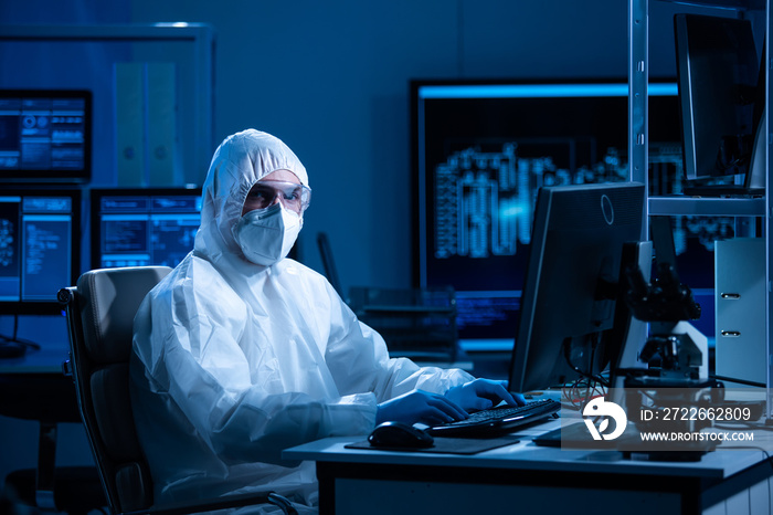 Microelectronics engineer works in a modern scientific laboratory on computing systems and microprocessors. Electronic factory worker is testing the motherboard and coding the firmware.