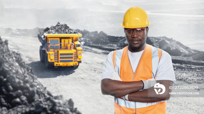 Happy african industrial worker engineer background big yellow mining truck for coal. Concept open pit mine industry geology