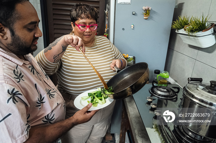 Plus sized parents making a healthy meal for the family