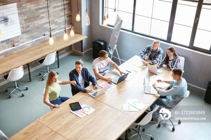 Young people having business meeting in modern office