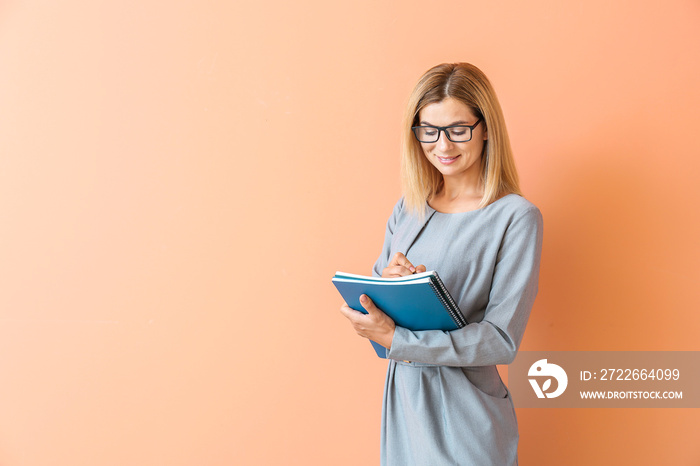 Beautiful female teacher on color background