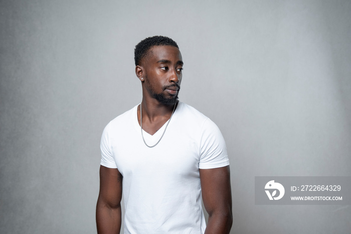 Portrait of man wearing white t-shirt and necklace