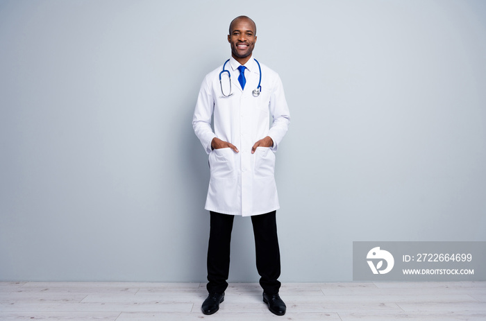 Full length photo of doctor intern dark skin guy good mood friendly smiling to patients virologist search disease test people wear white lab coat neck tie isolated grey color background