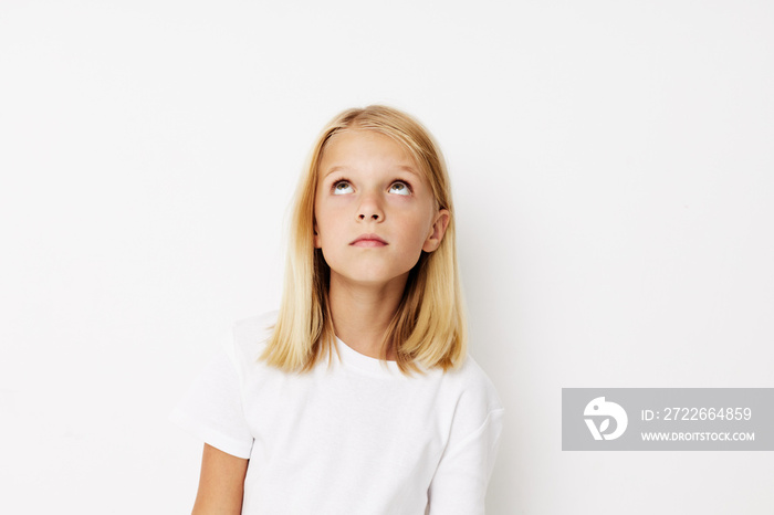 emotional girl in a white t-shirt grimace kids lifestyle concept