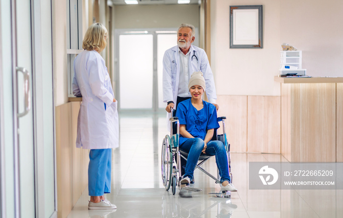 Professional medical doctor team with stethoscope in uniform discussing with patient woman with cancer cover head with headscarf of chemotherapy cancer in hospital.health care concept