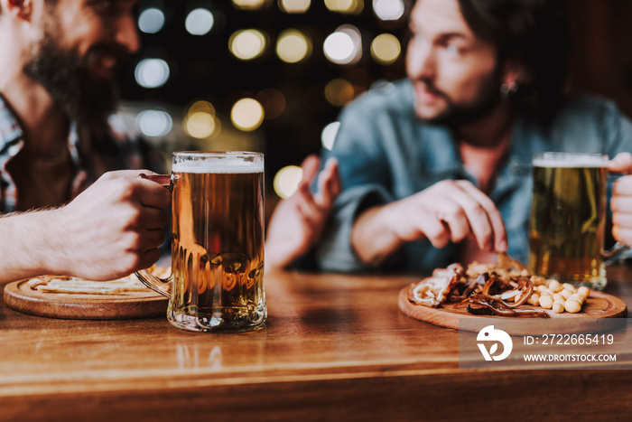 Friends enjoying drinks and snacks while spending time at pub