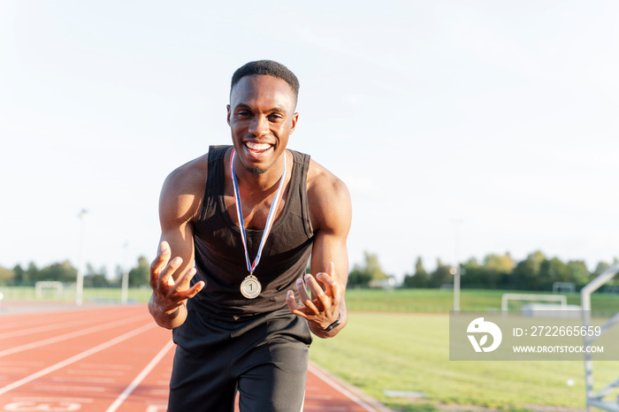 Portrait of athlete celebrating with medal