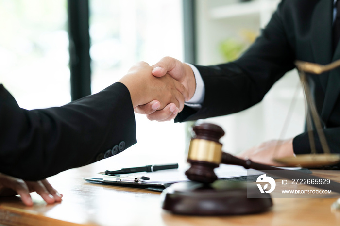 Judge and Businessman shaking hands after behind-the-scenes advice at attorney services concept courtroom.