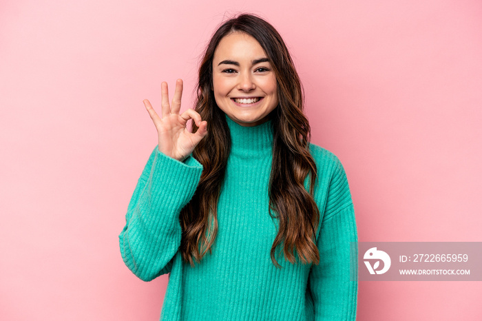 Young caucasian woman isolated on pink background cheerful and confident showing ok gesture.