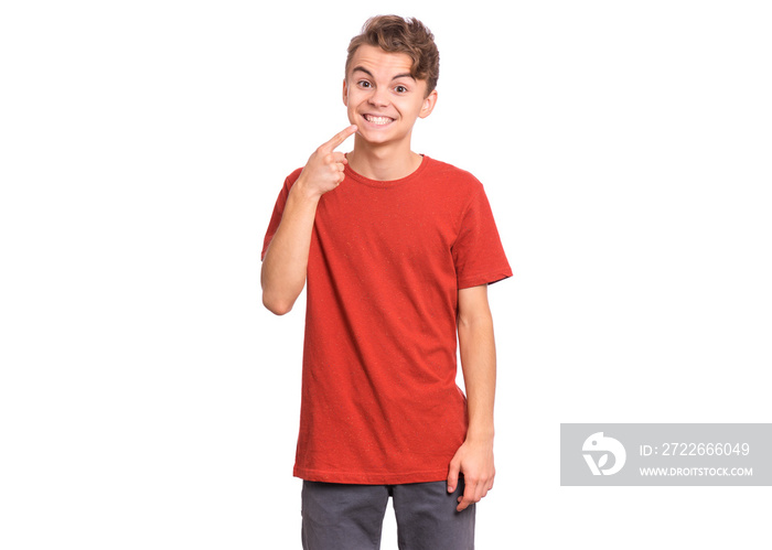 Handsome teen boy showing his to teeth, isolated on white background