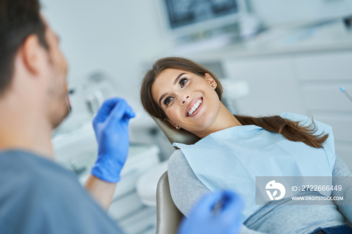 Male dentist and woman in dentist office