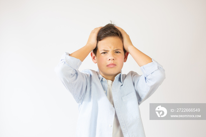 Portrait of unhappy teen boy, stressed with hand on head. Cute young caucasian teenager fears and upset for mistake. Sad child close eyes shocked, isolated on white background.