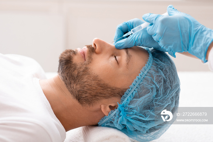 Handsome caucasian businessman getting injection in his nose